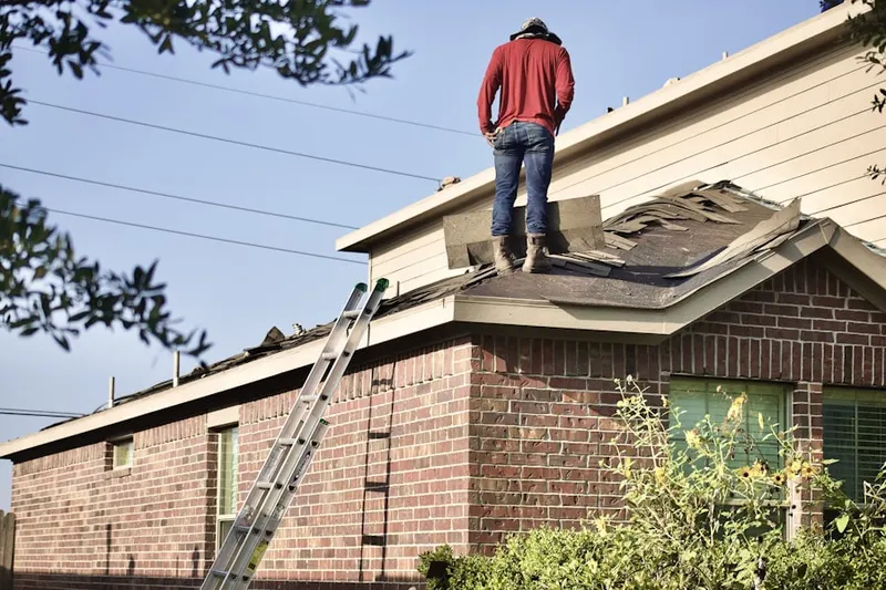 Professional roofer working on a residential roof in East Lewistown